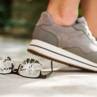 Person stepping on glasses